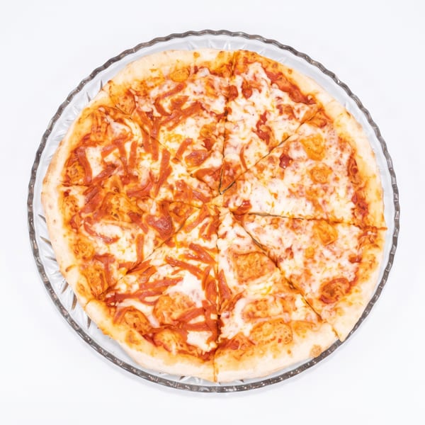 A whole cheese pizza with tomato sauce, cut into slices, on a clear glass plate.