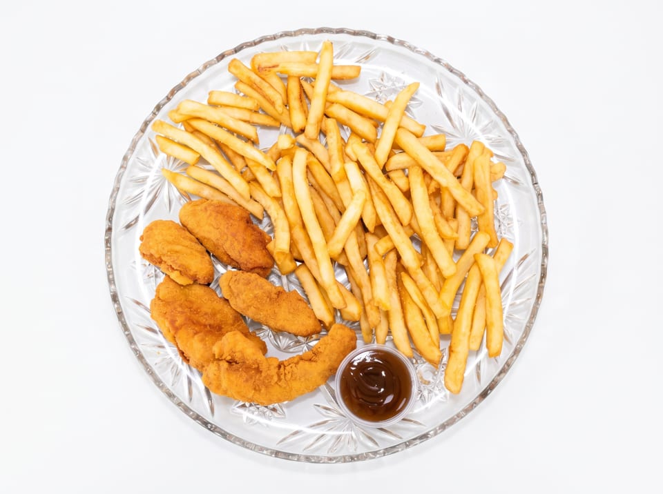 Golden french fries, crispy chicken tenders, and a small cup of barbecue sauce on a clear plate.